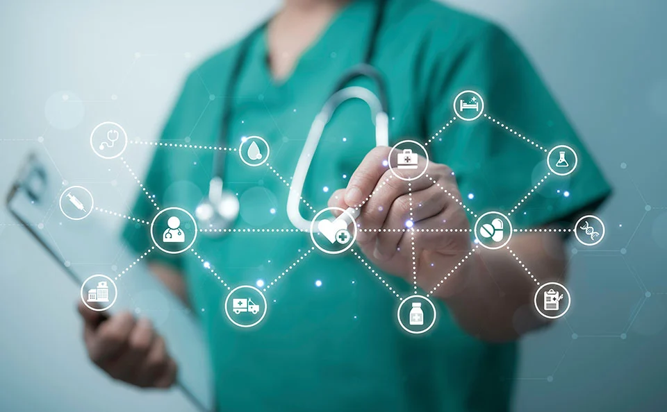 Physician with stethoscope using technology.