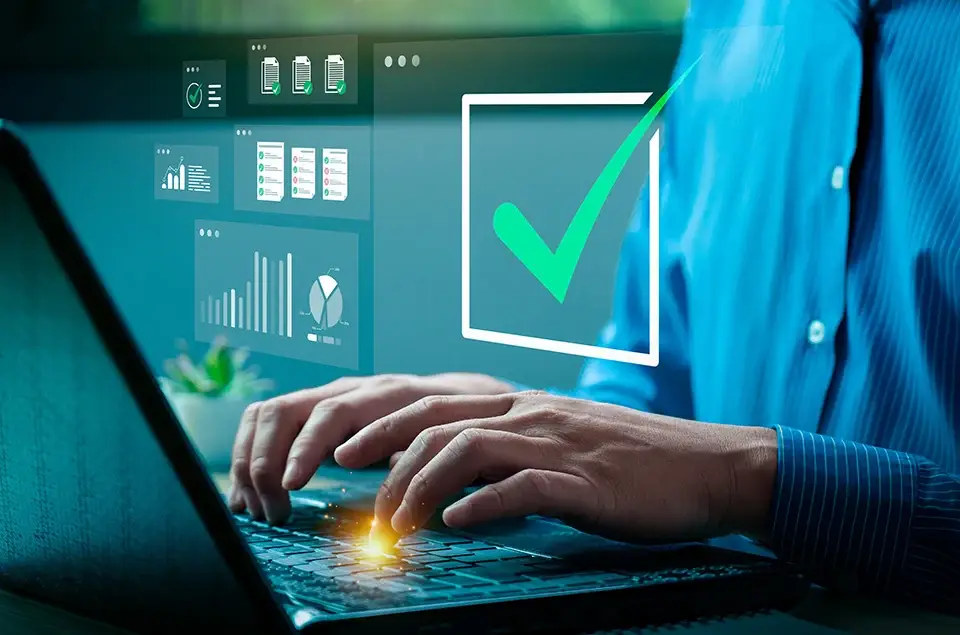 Health plan executive on laptop with visual of data and charts